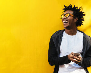 Portrait of handsome afro man using his mobile.